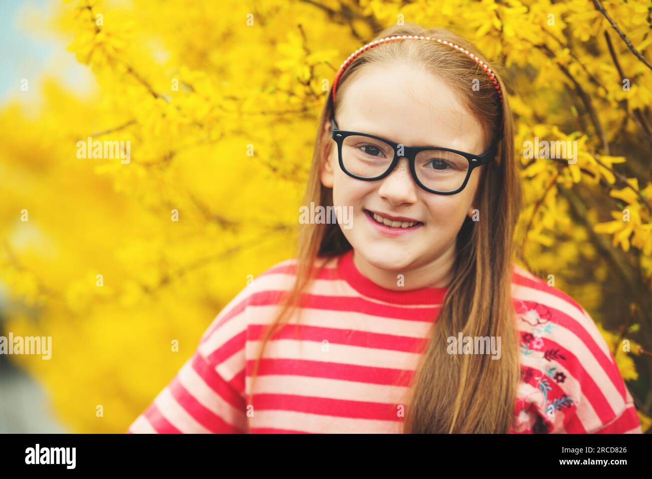 Outdoor portrait of a cute little girl in glasses Stock Photo - Alamy