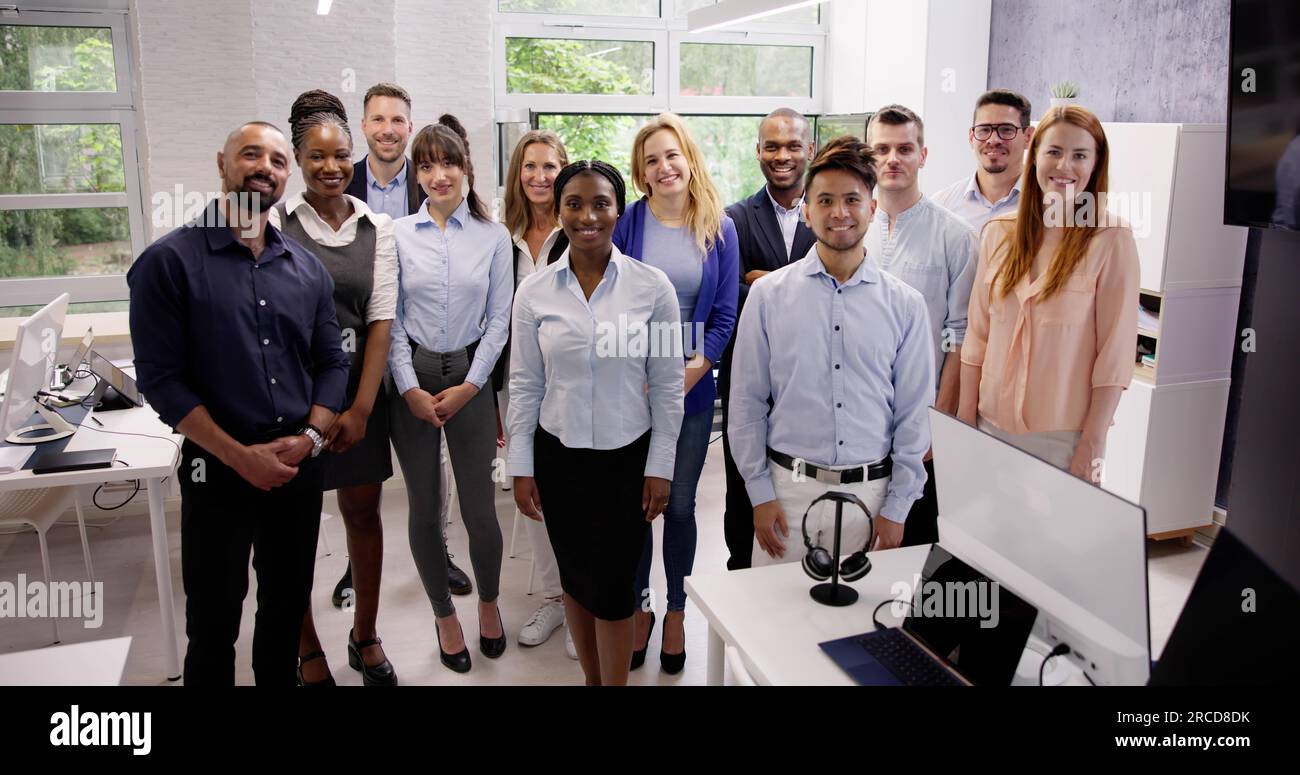 Happy Group Of Business People Standing In Office Stock Photo