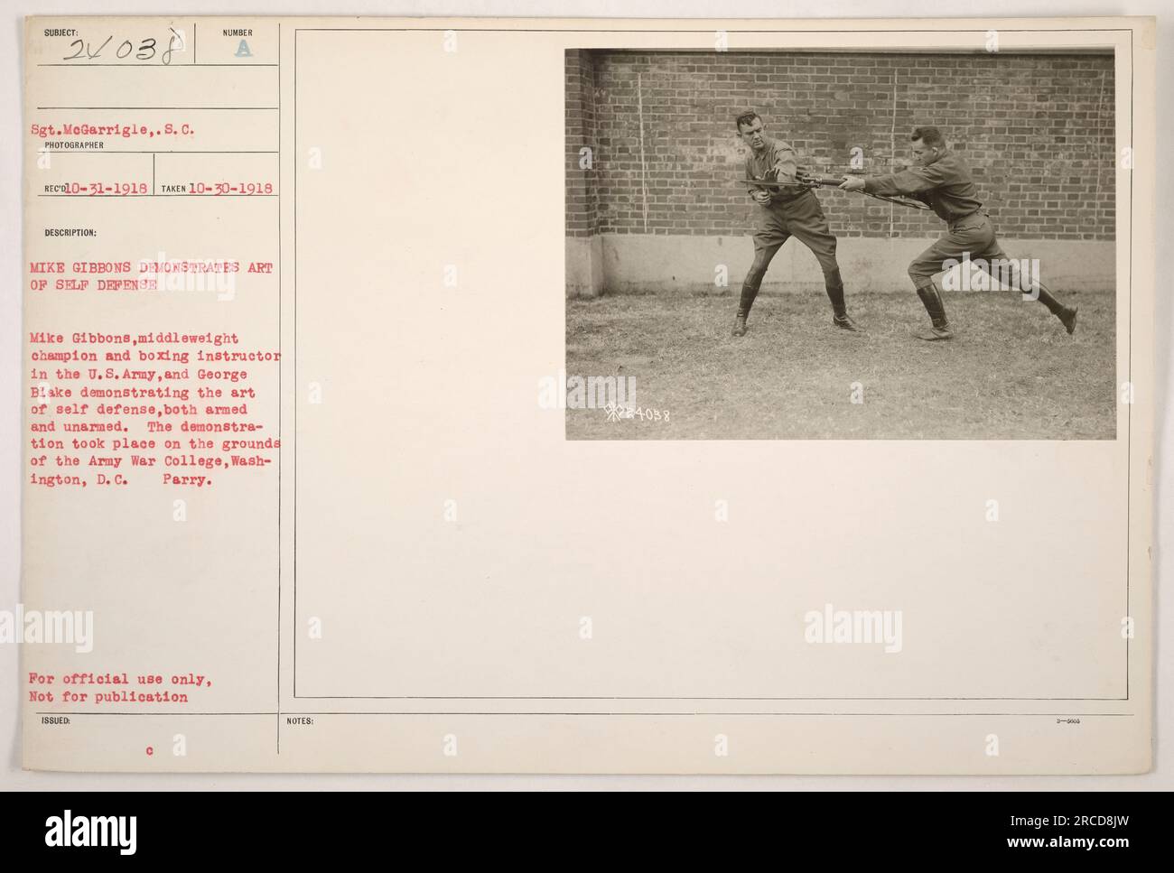 Sgt. MeGarrigle took a photograph on October 30, 1918, depicting Mike Gibbons, a middleweight champion and boxing instructor in the U.S. Army, along with George Blake, demonstrating self-defense techniques, both armed and unarmed. The demonstration occurred at the Army War College in Washington, D.C. This photograph is labeled as 111-SC-24038. Stock Photo