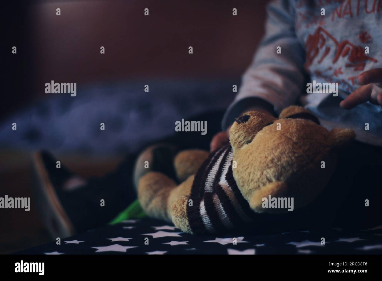 Baby playing with a teddy bear Stock Photo - Alamy