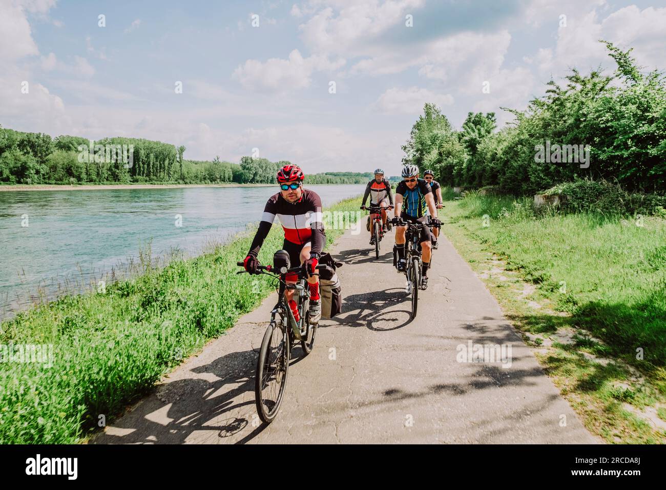 A group of friends cycling in the River Rin route, Germany Stock Photo