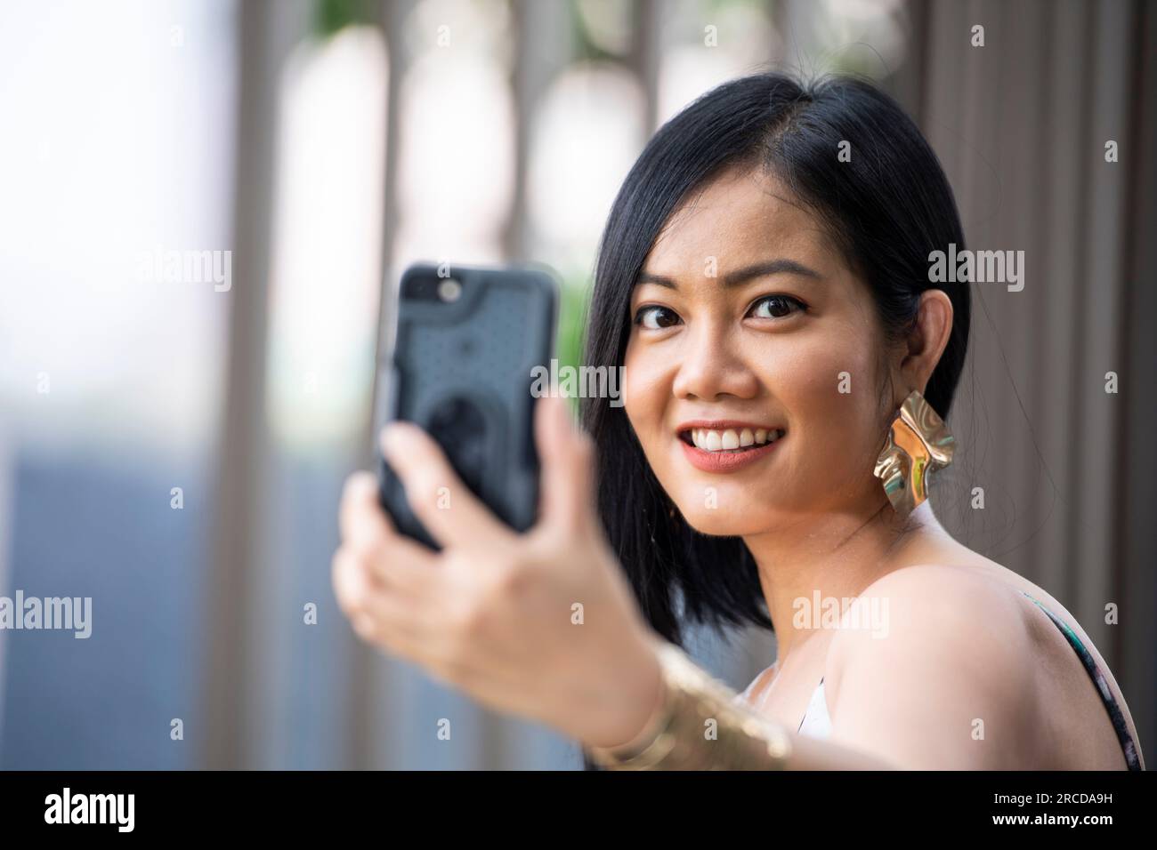 Thai woman taking a selfie with smartphone Stock Photo