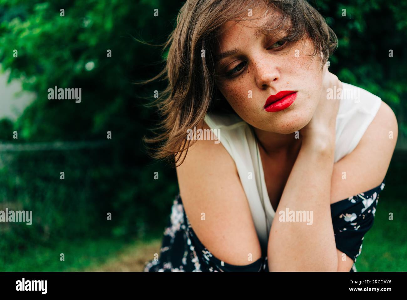 Young woman outside surround by green nature Stock Photo