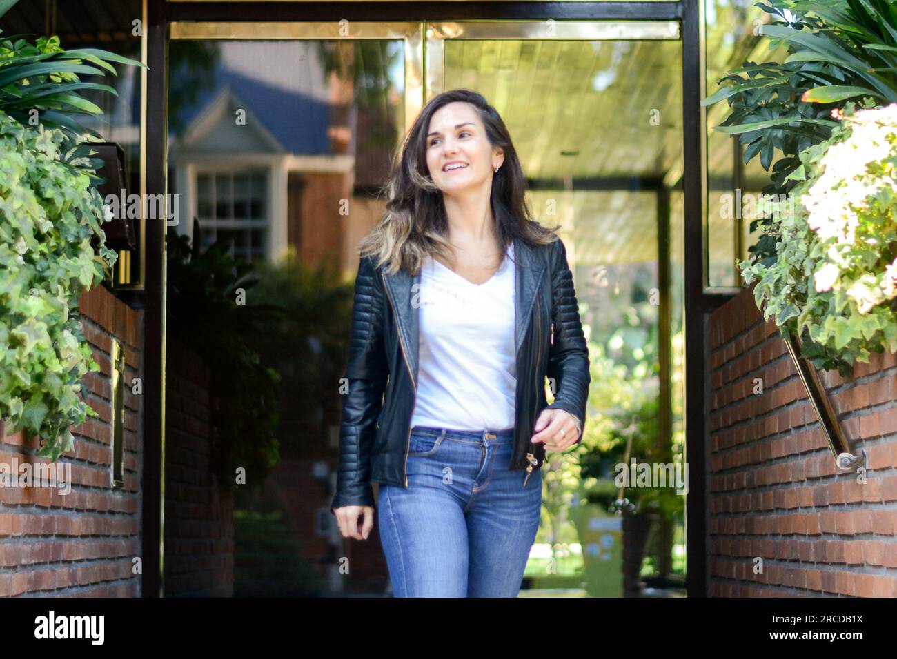 Woman looking away while walking through building Stock Photo