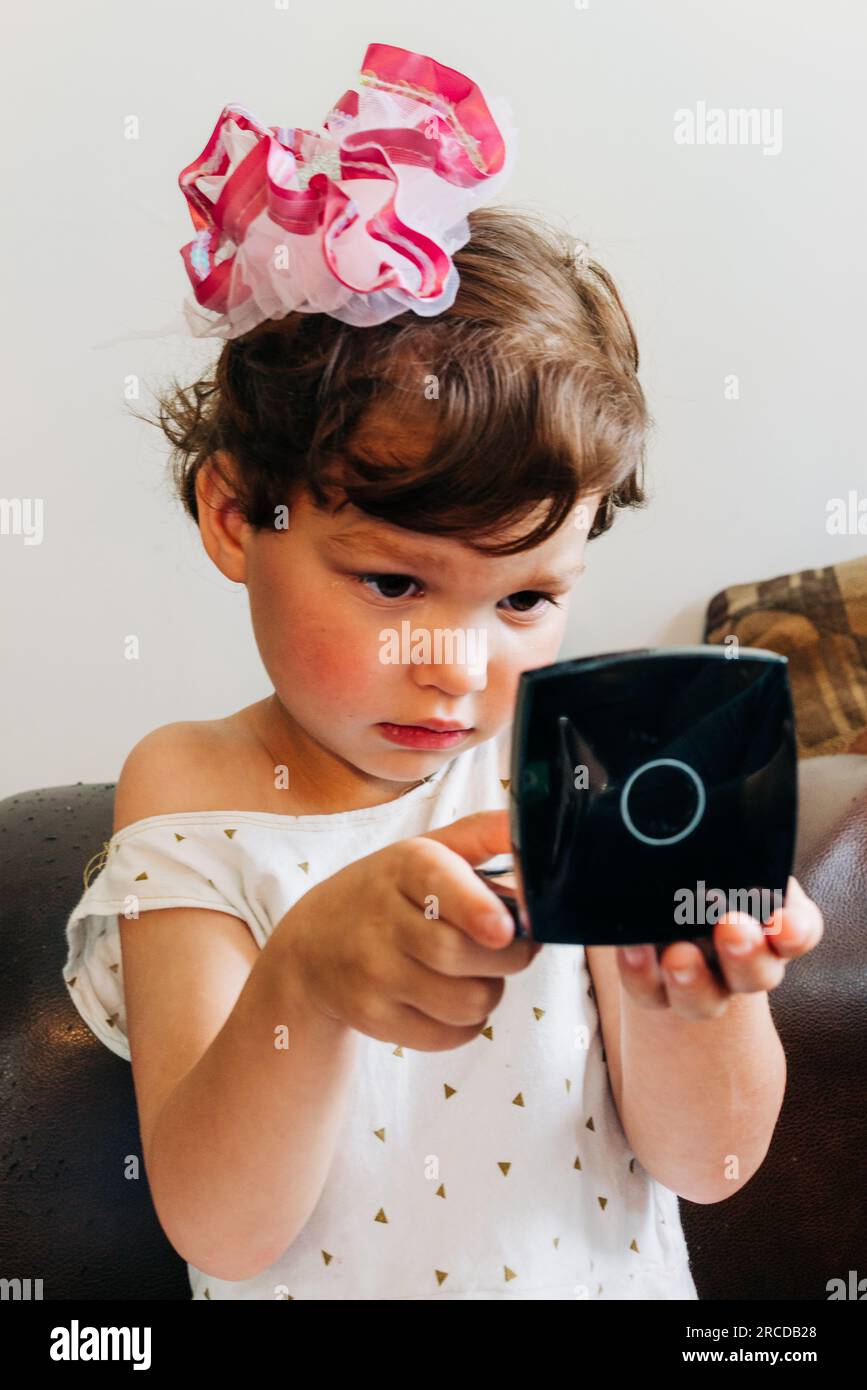 little girl looking in the mirror Stock Photo Alamy
