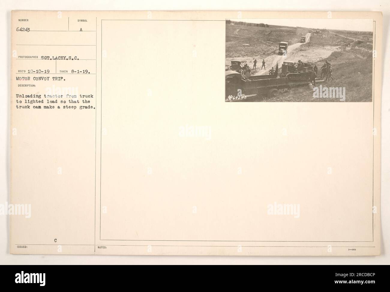 Soldiers unloading a tractor from a truck to reduce weight and allow ...