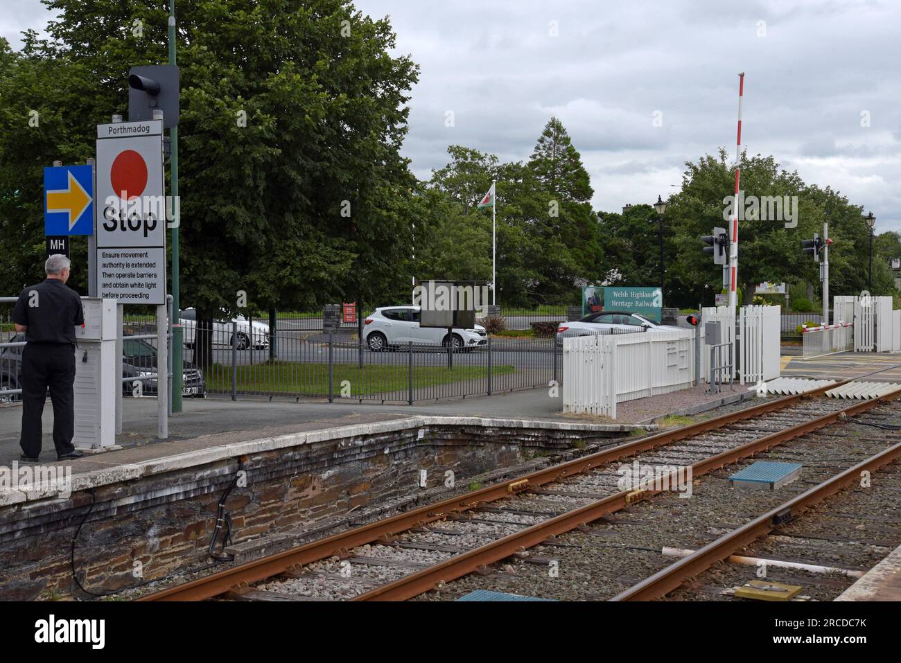 A Transport for Wales train driver operating level crossing permission equipment at Porthmadog
