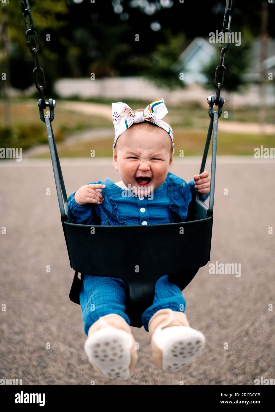Baby Laughing in Swing At Park Stock Photo Alamy