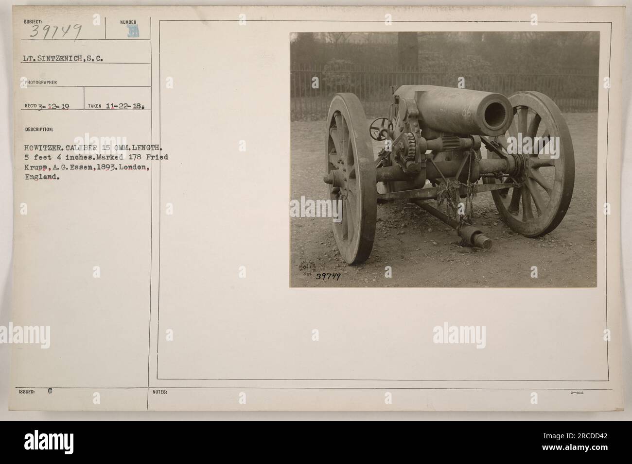 A photograph of Lieutenant Sintzenich, a photographer from the Signal Corps, capturing an image of a 15mm caliber howitzer. The howitzer is 5 feet 4 inches long and is marked as number 178, made by Fried Krupp, A.G. Essen in 1893. The photograph was taken on November 22, 1918, and the image is part of the 39749 collection. Stock Photo