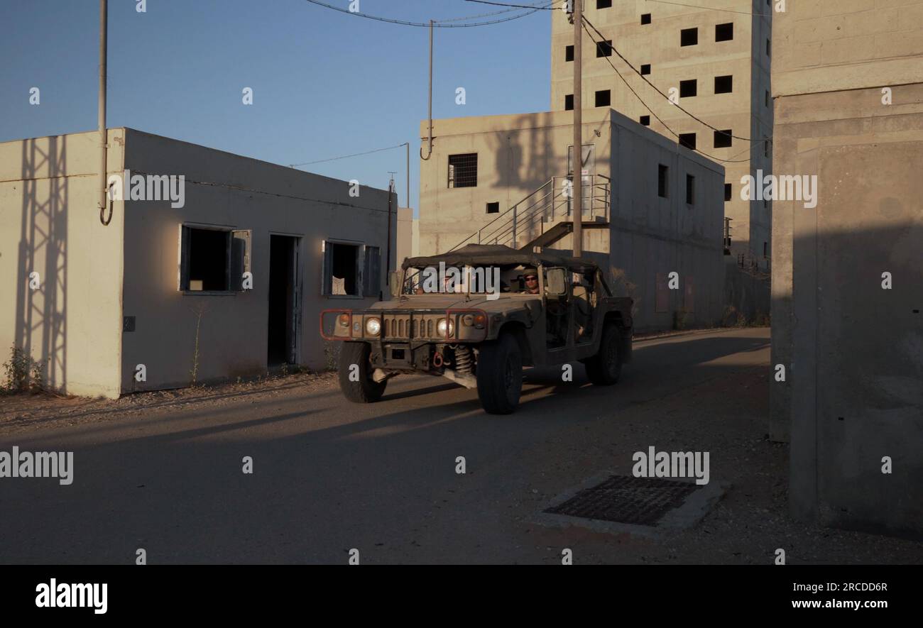 Israeli combat soldiers drive through a simulated residential ...