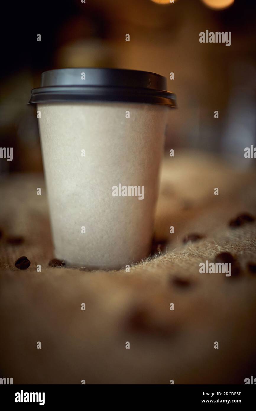 Close up of cardboard cup of coffee to go, with plastic cover Stock Photo