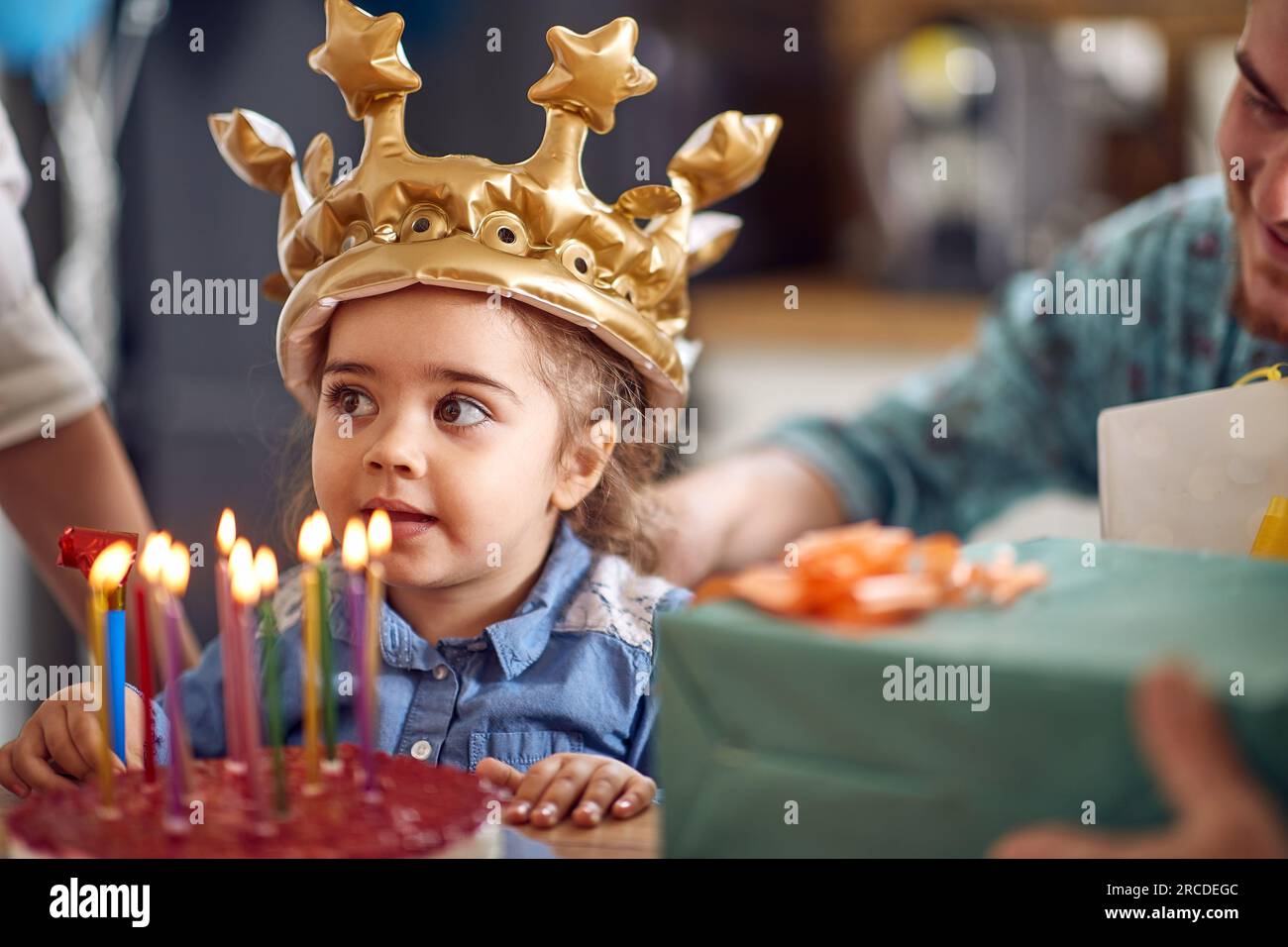 Young girl is seen in a closeup, beaming with joy, as she stands