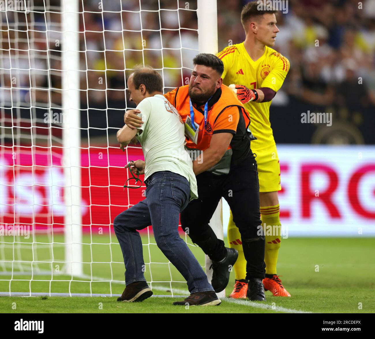 Gelsenkirchen, Deutschland. 20th June, 2023. firo : 06/20/2023, football, soccer: DFB national team, Germany, friendly match, GER, Germany - Colombia 0: 2 A speedster, climate activist, climate nutcase runs onto the field is prevented by a folder from chaining himself to the goal post, right TER STEGEN/dpa/Alamy Live News Stock Photo