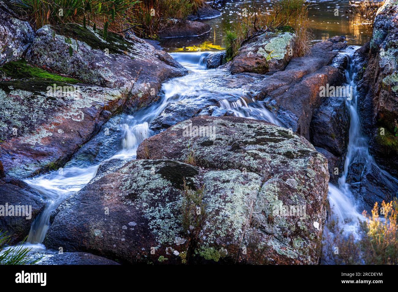 Small waterfall cascades over granite rocks, Glen Elgin Creek, New