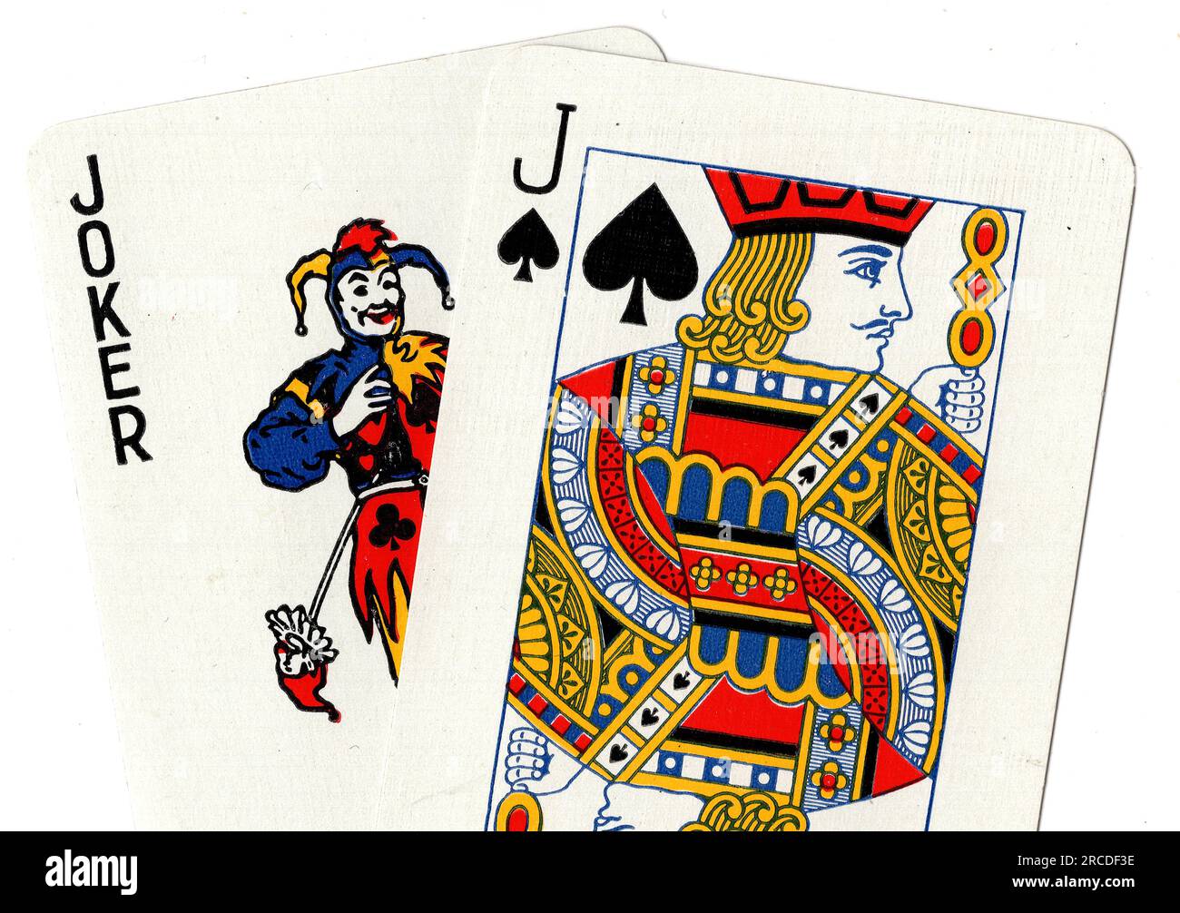 Vintage playing cards showing a joker and a jack of spades on a white