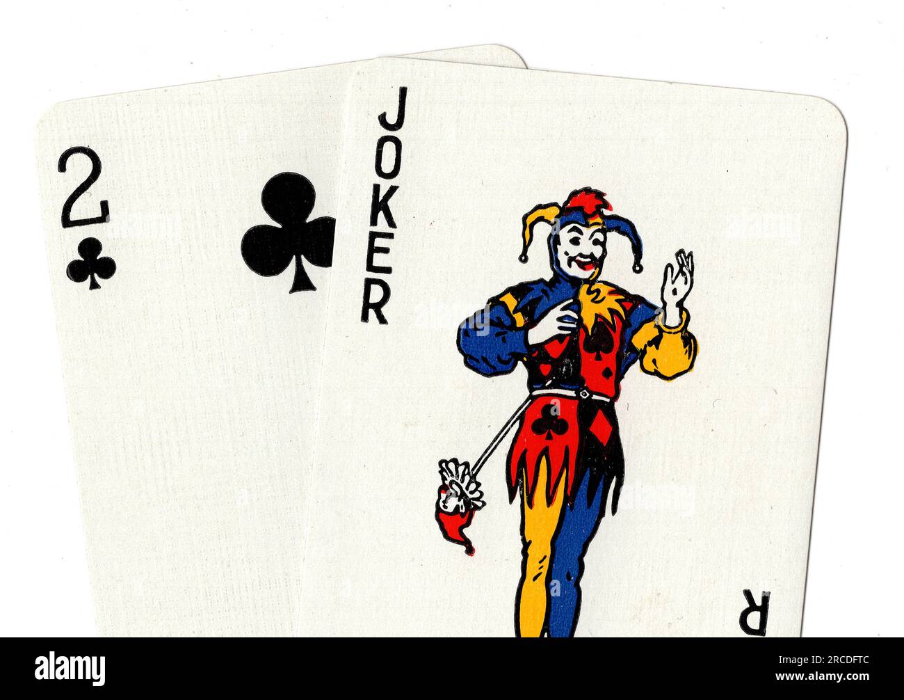 Vintage playing cards showing a joker and two of clubs on a white
