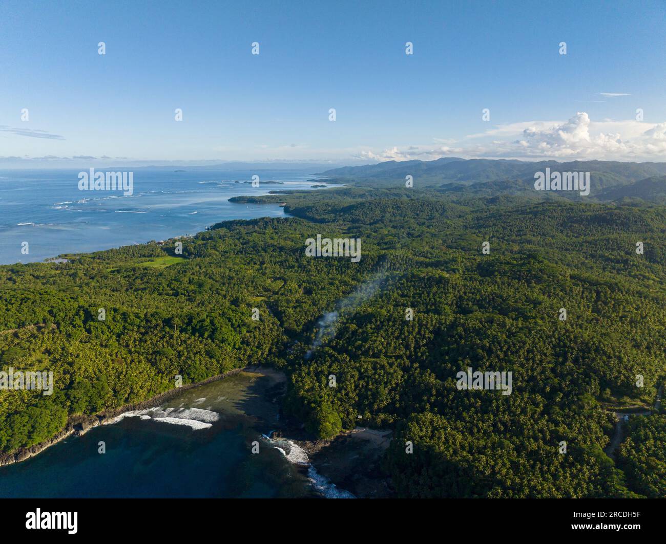 Top view of Tropical Landscape. Blue sky and ocean waves. Surigao del Sur. Mindanao, Philippines. Stock Photo