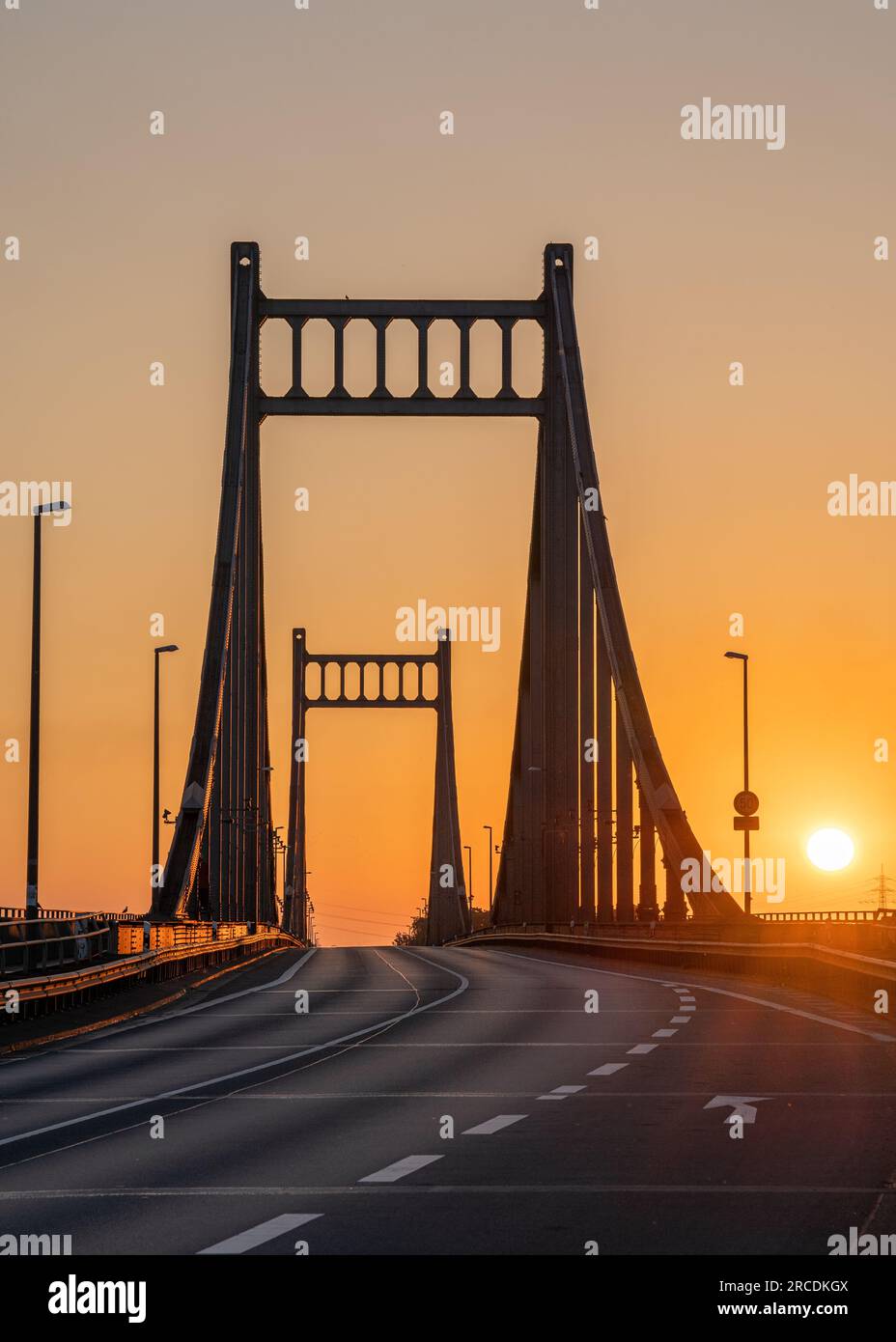 Old bridge crossing the Rhine river during sunrise, Krefeld, North Rhine Westphalia, Germany Stock Photo