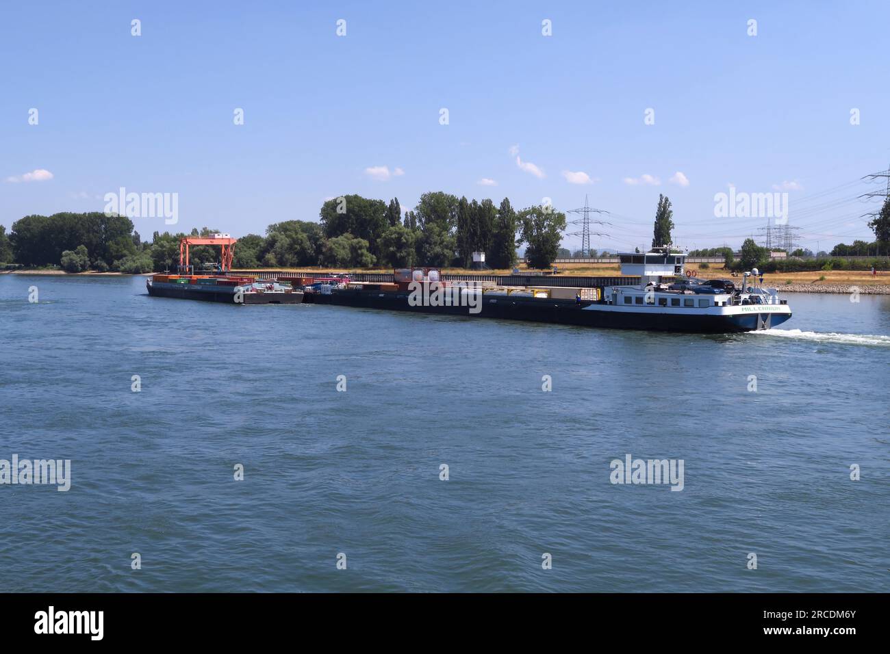 MV Millennium, a container barge makes its way up the River Rhine near Bildis, Germany Stock Photo