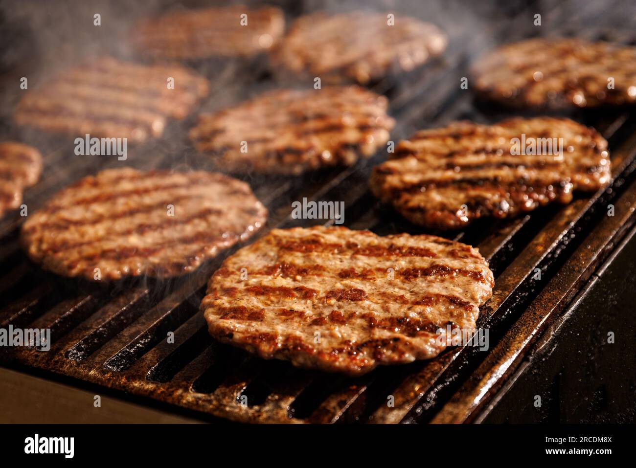 Round hamburger patties cooked on the barbeque grill Stock Photo Alamy