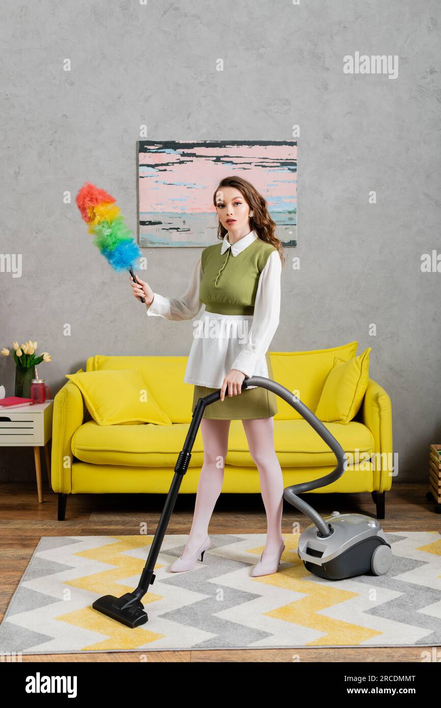 housekeeping concept, young woman with wavy hair standing on carpet and