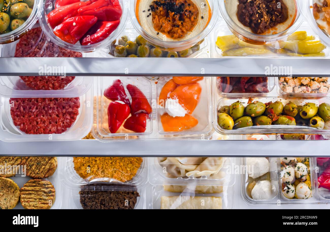 A display of variety of prepackaged food products in plastic boxes ...