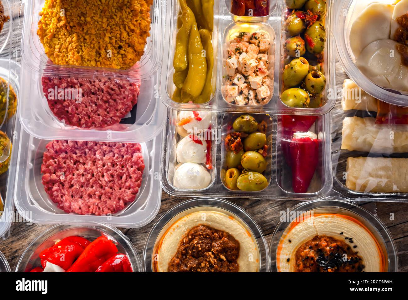 A display of variety of prepackaged food products in plastic boxes