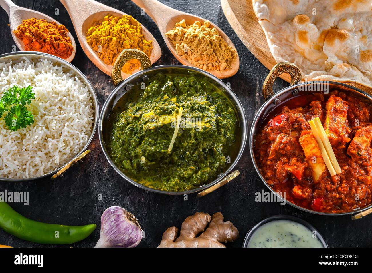 https://c8.alamy.com/comp/2RCDR4G/composition-with-indian-dishes-madras-paneer-palak-paneer-and-shahi-paneer-with-basmati-rice-served-in-original-indian-karahi-pots-2RCDR4G.jpg