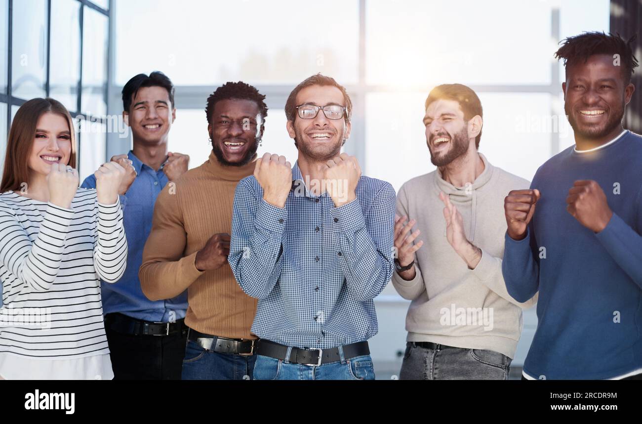 Business people celebrates and clench their fists in the air as a winning team Stock Photo