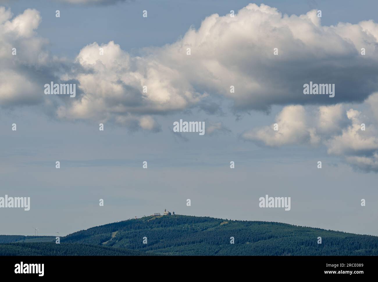14 July 2023, Saxony, Bärenstein: Clouds drift over the 1215 meter high Fichtelberg in the Ore Mountains. The region around Saxony's highest mountain is an attraction for many vacationers. Photo: Hendrik Schmidt/dpa Stock Photo
