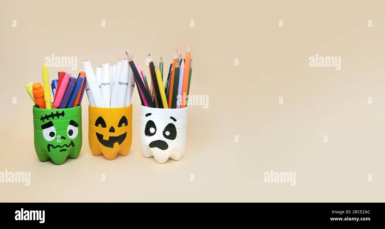 The art of handmade recycling from plastic bottle. Halloween craft ideas of container for pencils. Crafts for the children's room Stock Photo