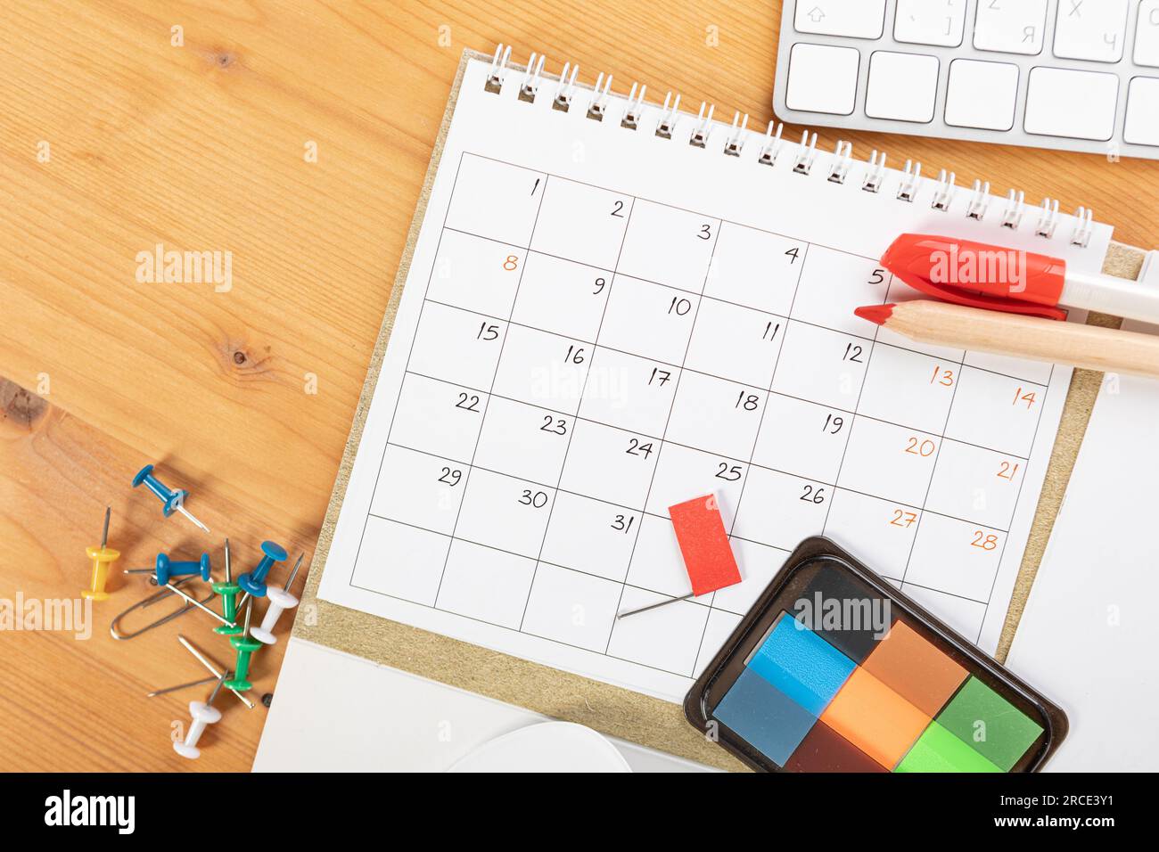 Calendar and agenda reminders, work from home online. desktop calendar with  stationery and pen pencil, keyboard. mark a holiday trip or plans in a dia  Stock Photo - Alamy
