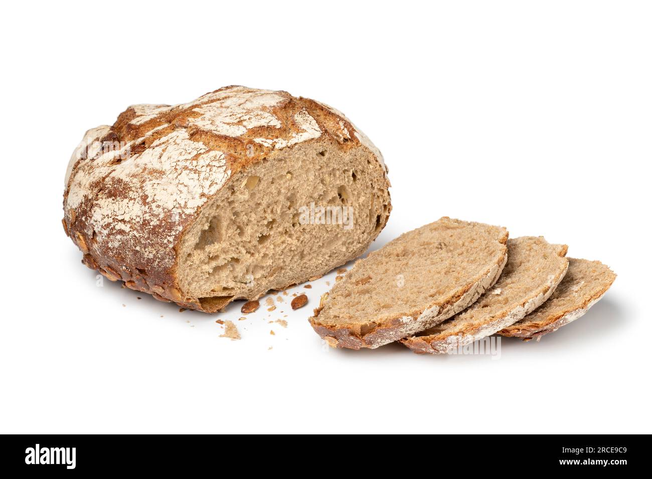 Fresh baked sourdough loaf of bread with pumpkin seeds and slices close up isolated on white background Stock Photo