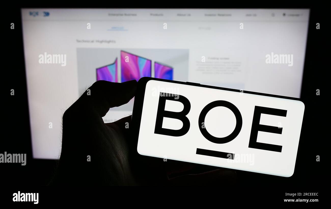 Person holding cellphone with logo of Chinese company BOE Technology