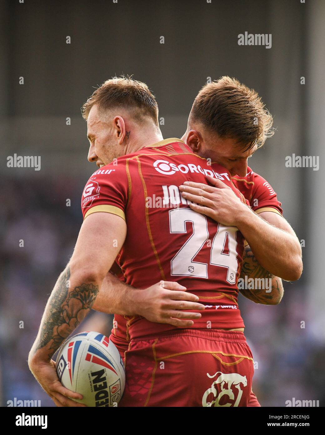 St. Helens, England - 13th July 2023 - Tom Davies congratulates try scorer Tom Johnstone of Catalan Dragons . . Betfred Super League , St. Helens vs Catalan Dragons at Totally Wicked Stadium, St. Helens, UK Stock Photo