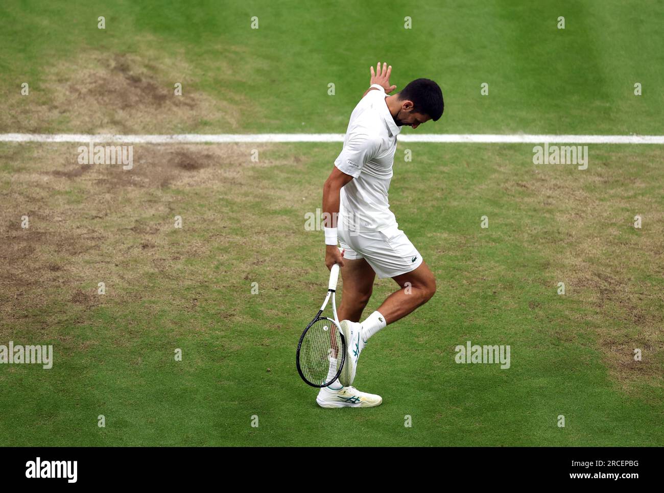 Novak Djokovic hits his shoe with his racquet during the Gentlemen's