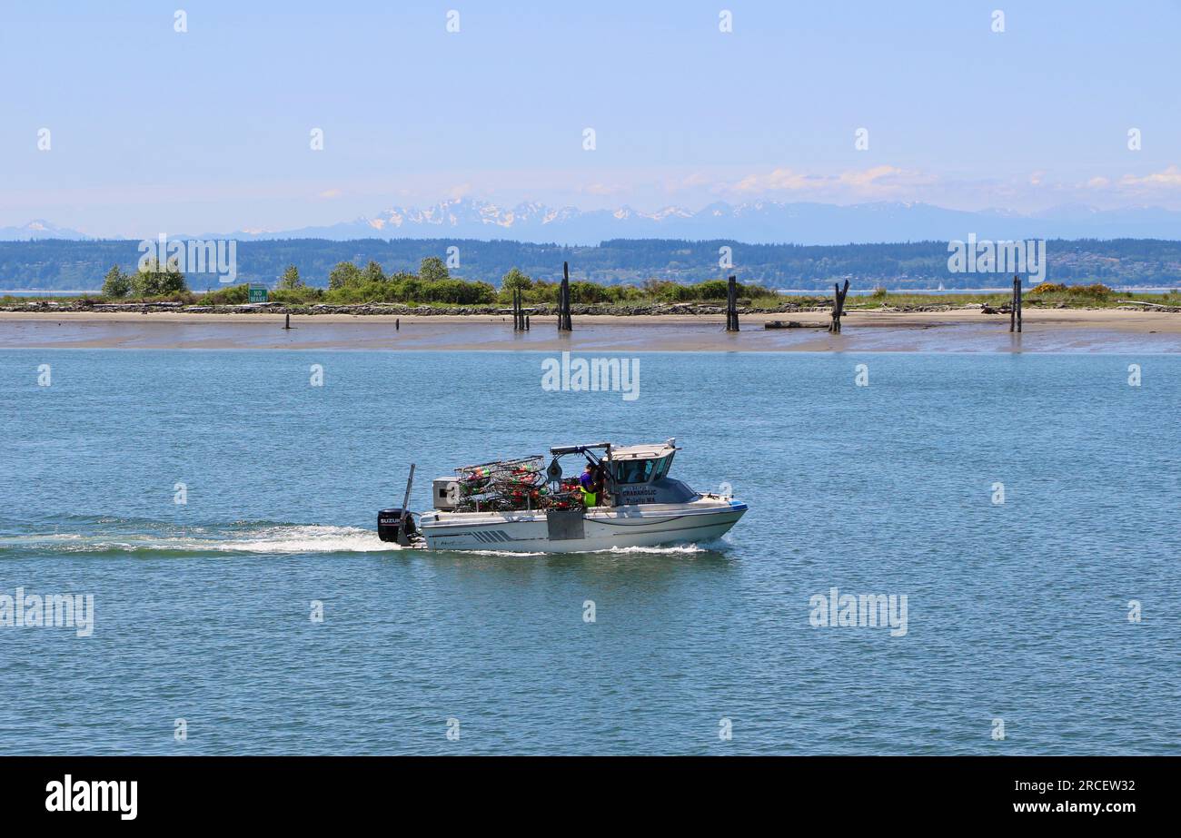 Crab boat from Tulalip Marina with crab traps under way passing Jetty