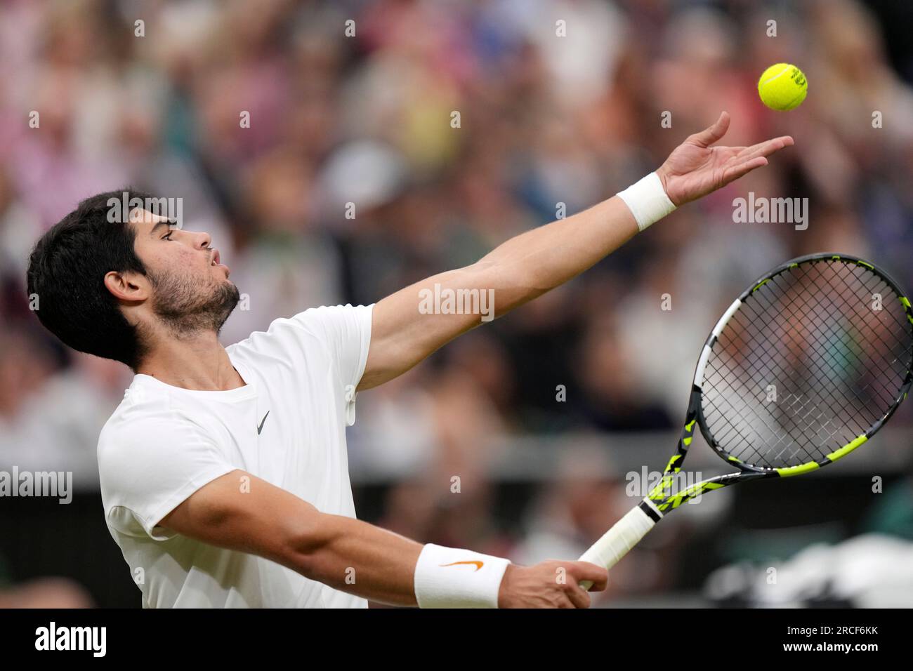 Spains Carlos Alcaraz serves against Russias Daniil Medvedev during their mens singles semifinal match on day twelve of the Wimbledon tennis championships in London, Friday, July 14, 2023