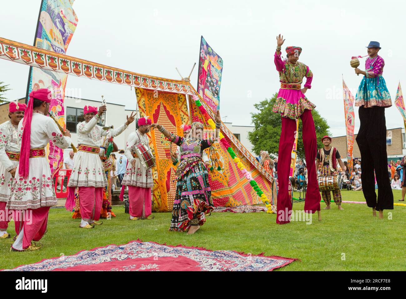 Dancers and stilt walkers perform in colourful traditional Punjab dress