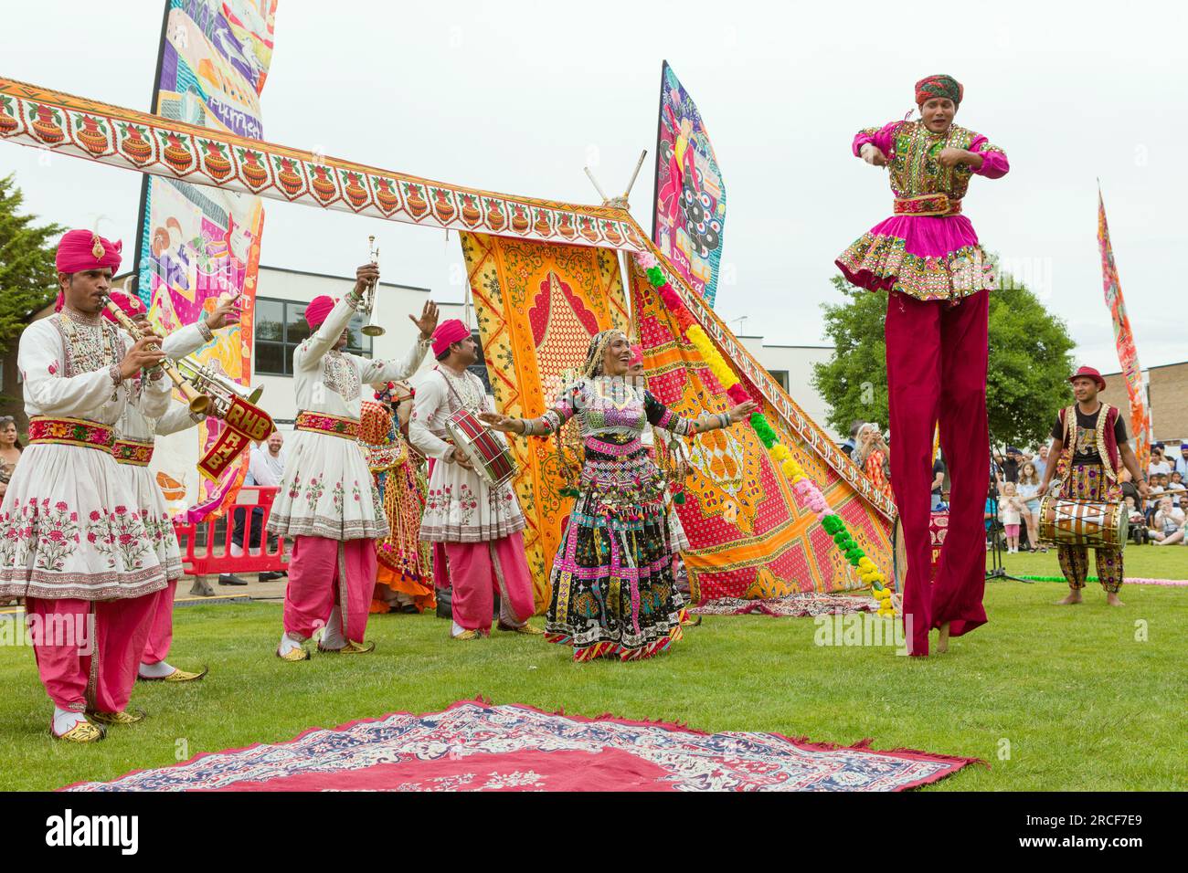 Dancers and stilt walkers perform in colourful traditional Punjab dress