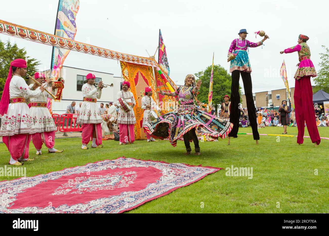 Dancers and stilt walkers perform in colourful traditional Punjab dress