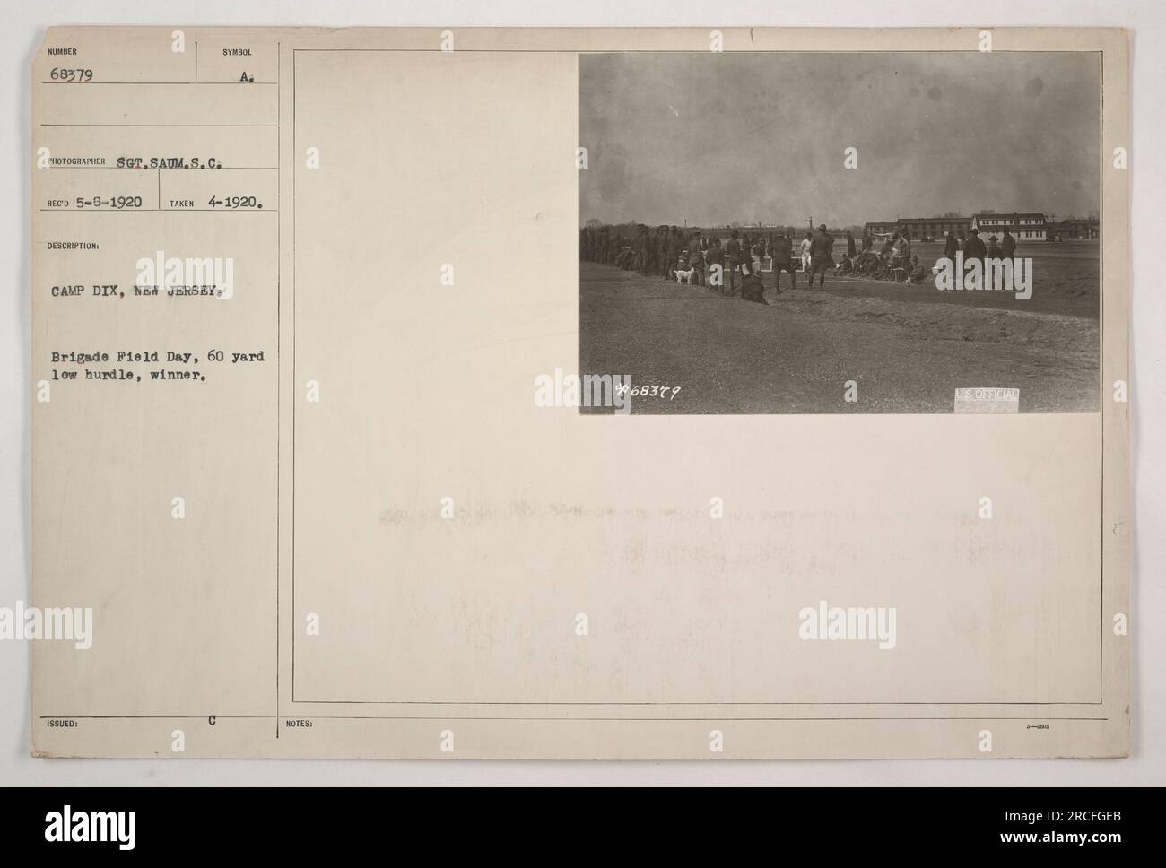 Soldier competing in a 60 yard low hurdle event during Brigade Field Day at Camp Dix in New Jersey. The photograph was taken by Sgt. Saum, S.C. on April 1920, and the winner's number is 68379. This image is from the Photographs of American Military Activities during World War One collection. Stock Photo