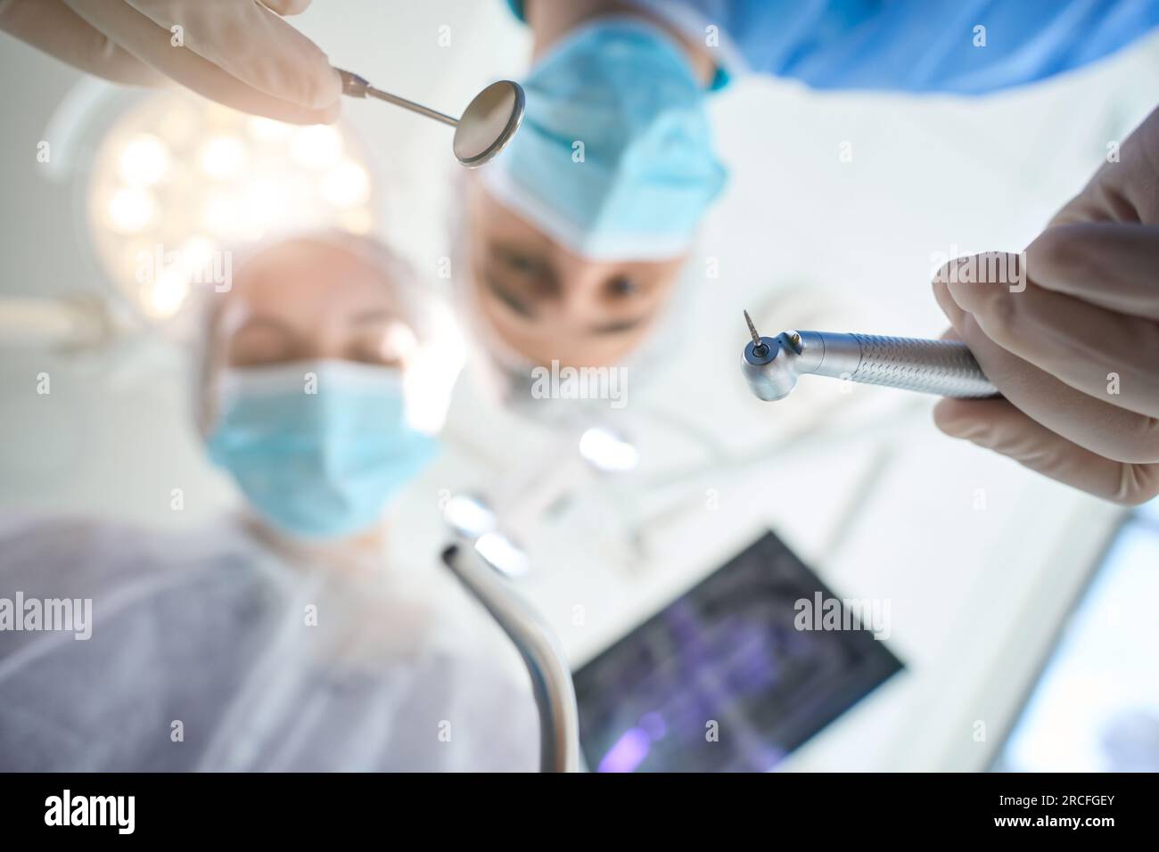 Surgeon dentist with dental mirror in his hands at workplace Stock