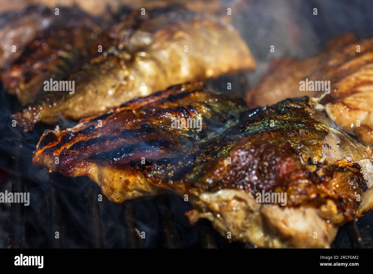 Grilled mackerel fish with smoke on a charcoal barbecue grill Stock Photo Alamy