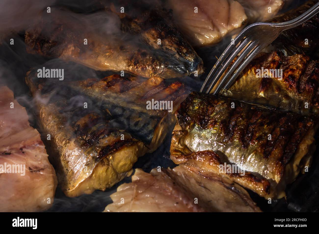 Grilled mackerel fish with smoke on a charcoal barbecue grill Stock Photo Alamy