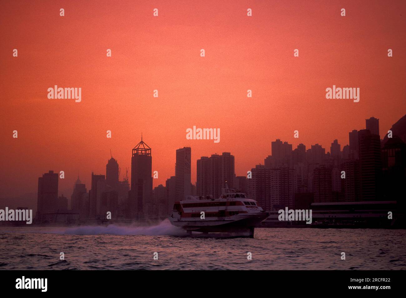 High speed hydrofoil ferry boat between Hong Kong and Macau on the Victoria harbour in front of the Skyline of Central Hongkong from the viewpoint of Stock Photo