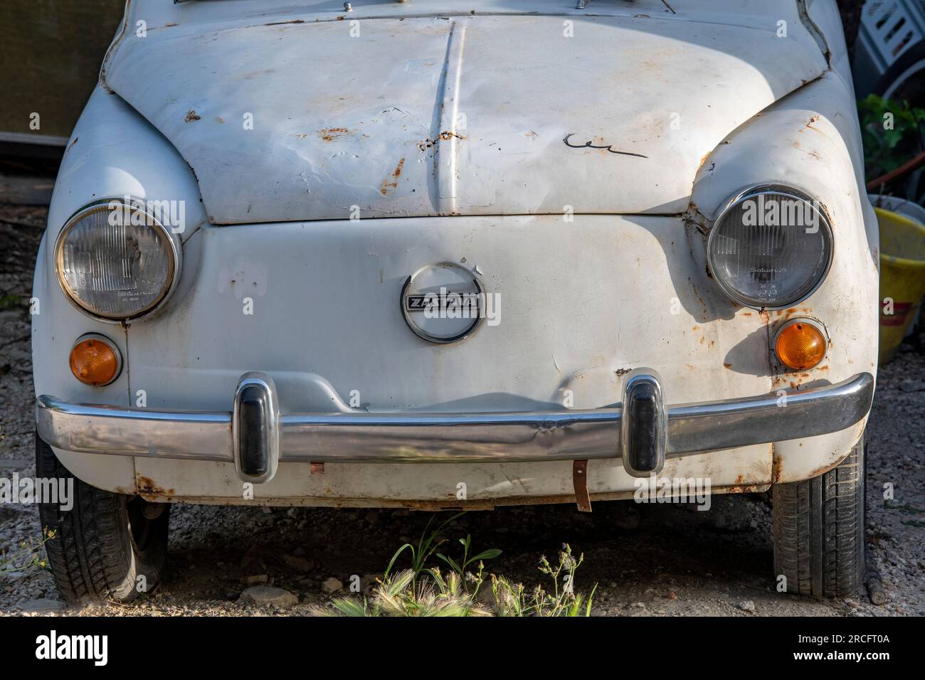 front of old rusty zastava motor car, vintage zastava car, bonnet hood of eastern european zastava motor car. Stock Photo
