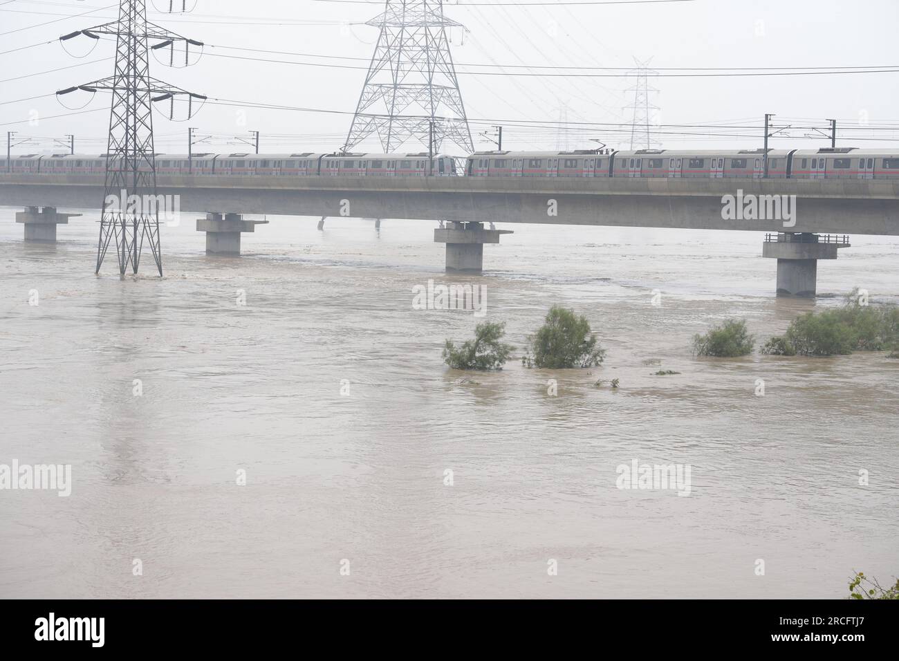 New Delhi, India. 13th July, 2023. Shopkeepers swim to guard their flood water submerged shops