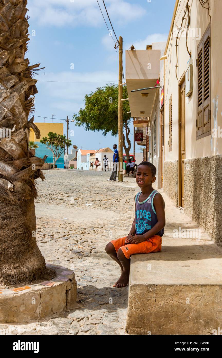 A Young African Boy Sitting in the Street, Boa Vista, Cape Verde, Africa Stock Photo