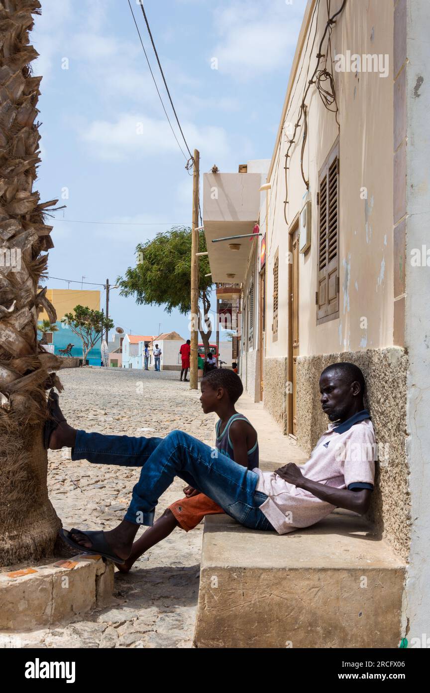 An African Father Sitting with his Child on the Street, Boa Vista, Cape Verde, Africa Stock Photo